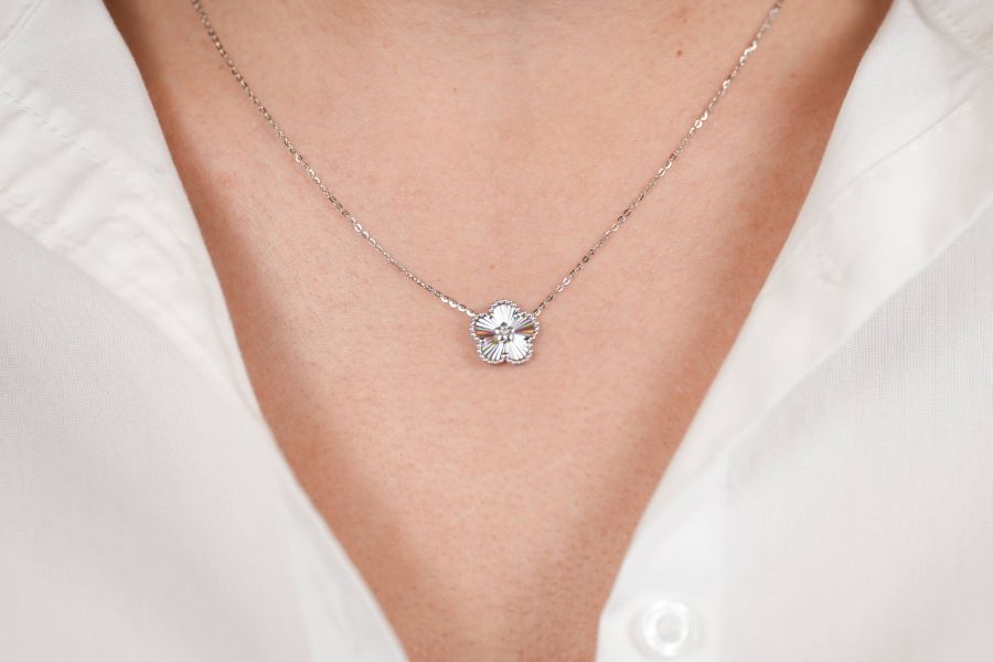 woman wearing white gold flower necklace