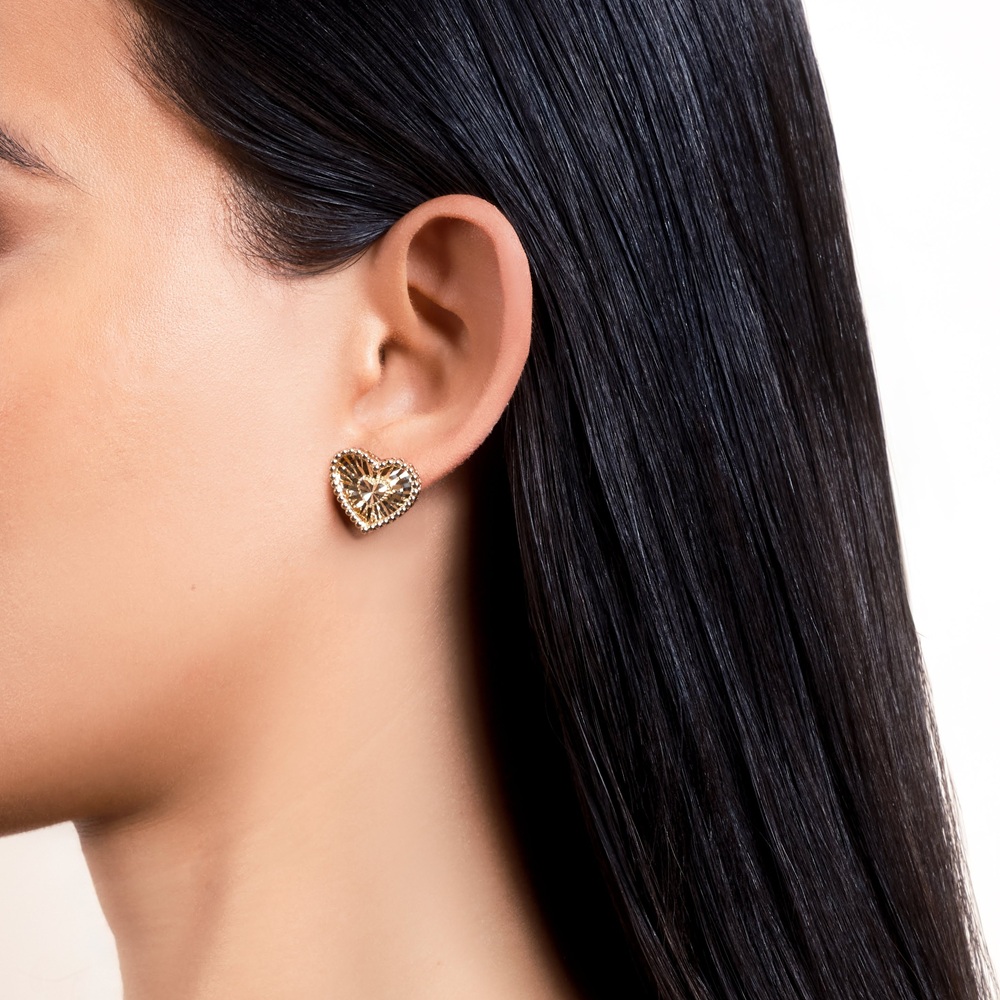 heart ear piercing earrings on ear